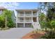 Lovely two-story home with balconies, green landscaping, and a driveway leading to a two-car garage at 1801 Landfall Way, Seabrook Island, SC 29455