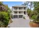 Beautiful two-story home with a charming front porch, balconies, and lush landscaping at 1801 Landfall Way, Seabrook Island, SC 29455