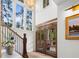 Bright foyer with custom double doors, staircase, chandelier, and large windows at 1801 Landfall Way, Seabrook Island, SC 29455