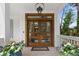 Beautiful wood front door with glass panels and potted flowers on a covered porch at 1801 Landfall Way, Seabrook Island, SC 29455