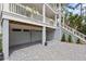 Lower level garage and entrance with elegant design and manicured landscaping at 1801 Landfall Way, Seabrook Island, SC 29455