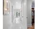 Bright hallway leading to bathroom features white tile floors and closet access at 1801 Landfall Way, Seabrook Island, SC 29455