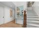 Elegant hallway with hardwood floors, staircase, artwork and large mirror at 1801 Landfall Way, Seabrook Island, SC 29455