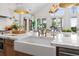 Kitchen island featuring a prep sink, modern fixtures, and marble countertops at 1801 Landfall Way, Seabrook Island, SC 29455