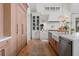 Well-appointed kitchen with custom cabinets, stainless steel appliances, and a farmhouse sink at 1801 Landfall Way, Seabrook Island, SC 29455