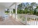 Relaxing porch featuring a rocking chair and a beautiful view of the surrounding greenery at 1801 Landfall Way, Seabrook Island, SC 29455