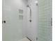 Clean shower with sleek showerhead, built-in shelves, and glass door at 1801 Landfall Way, Seabrook Island, SC 29455