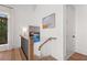 Bright staircase with hardwood floors and decorative artwork at 1801 Landfall Way, Seabrook Island, SC 29455