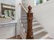 Staircase with detailed wood banister, neutral runner, and white walls at 1801 Landfall Way, Seabrook Island, SC 29455