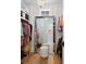 Well-organized walk-in closet features hardwood floors, shelving, and a large mirror at 1801 Landfall Way, Seabrook Island, SC 29455