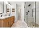 Modern bathroom featuring a double vanity, glass shower, and stone flooring at 1817 Towne St, Johns Island, SC 29455