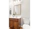 Bathroom with vanity, mirror, sink, toilet, and wall-mounted towel rack and holder at 1817 Towne St, Johns Island, SC 29455
