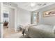 Bright bedroom with neutral tones, natural light from window, a bench seat, and a ceiling fan at 1817 Towne St, Johns Island, SC 29455