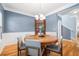 Dining room showcasing a wooden table with modern chairs, complemented by a china cabinet and hardwood floors at 1817 Towne St, Johns Island, SC 29455