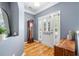 Elegant entryway features hardwood floors, soft blue walls, a stylish mirror, and an interior glass storm door at 1817 Towne St, Johns Island, SC 29455