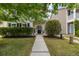Inviting front yard with lush green grass, trimmed hedges, and a walkway leading to the covered entryway at 1817 Towne St, Johns Island, SC 29455