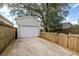 Detached garage with a white door and siding, set in a well-maintained backyard with a driveway at 1817 Towne St, Johns Island, SC 29455
