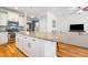 Open-concept kitchen featuring a large island with granite countertops, stainless steel appliances, and ample cabinet space at 1817 Towne St, Johns Island, SC 29455