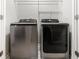 Laundry room featuring a modern washer and dryer set with stainless steel finishes and white walls at 1817 Towne St, Johns Island, SC 29455