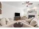 Bright living room with neutral tones, fireplace, and comfortable seating arrangement at 1817 Towne St, Johns Island, SC 29455