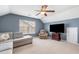 Spacious room with sectional couch, recliner, entertainment center and ceiling fan at 1817 Towne St, Johns Island, SC 29455