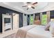 Bedroom features a tray ceiling, a wood accent wall and ample natural light at 1817 Towne St, Johns Island, SC 29455