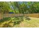 Large, grassy backyard surrounded by a wooden privacy fence and mature trees at 1917 Jason St, North Charleston, SC 29406