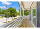 Balcony features wood flooring, black siding and white railings overlooking the neighborhood at 1917 Jason St, North Charleston, SC 29406