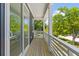 Balcony features wood flooring, black siding and white railings at 1917 Jason St, North Charleston, SC 29406