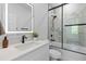 Modern bathroom featuring marble tile, a sleek vanity with an illuminated mirror, and glass shower doors at 1917 Jason St, North Charleston, SC 29406