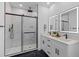 Modern bathroom featuring a glass-enclosed shower with black fixtures, dual vanities, and LED mirrors at 1917 Jason St, North Charleston, SC 29406