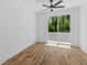 Bright bedroom features wood floors, a ceiling fan, and sliding glass doors to a balcony at 1917 Jason St, North Charleston, SC 29406