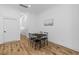 Modern dining area showcasing a black table set, with light wood floors and neutral decor at 1917 Jason St, North Charleston, SC 29406