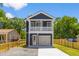 Two-story home featuring a modern design with a white garage door and trim, plus a second-story balcony at 1917 Jason St, North Charleston, SC 29406