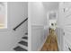 Hallway view showcases hardwood floors, white walls, and crown molding, leading to dining and living area at 1917 Jason St, North Charleston, SC 29406