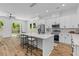 Bright kitchen features an island with bar seating, modern stainless appliances, and natural light streaming in from the patio doors at 1917 Jason St, North Charleston, SC 29406
