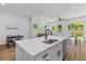 Open-concept kitchen with an island, stainless appliances, and views into the dining and living spaces at 1917 Jason St, North Charleston, SC 29406
