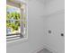 Neat laundry room features tile floor, window and shelf at 1917 Jason St, North Charleston, SC 29406