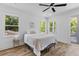 Bright bedroom boasts natural light from multiple windows and wood-style floors for a modern aesthetic at 1917 Jason St, North Charleston, SC 29406