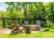 Relaxing backyard space featuring Adirondack chairs and a stone fire pit, perfect for entertaining guests at 2 Piedmont Ave # A, Charleston, SC 29403