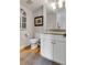 Charming bathroom features a wood-trimmed window, an elegant mirror and vanity, plus modern toilet and fixtures at 2 Piedmont Ave # 1/2, Charleston, SC 29403