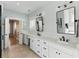 Bright bathroom boasts double sinks, sleek black hardware, and natural light, offering a spa-like experience at 2 Piedmont Ave # A, Charleston, SC 29403