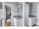 Dual sink bathroom with gray countertops, ample cabinetry, and modern fixtures with adjacent bedroom view at 2 Piedmont Ave # A, Charleston, SC 29403