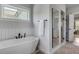 Bright bathroom with a soaking tub, sleek black fixtures, and a glass-enclosed shower at 2 Piedmont Ave # A, Charleston, SC 29403