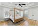 Serene bedroom with a four-poster bed, tray ceiling, and plenty of natural light at 2 Piedmont Ave # A, Charleston, SC 29403