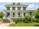 Inviting two-story home featuring a charming front porch and well-manicured lawn at 2 Piedmont Ave # A, Charleston, SC 29403