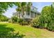 Beautifully landscaped backyard with a view of the home's exterior and porch at 2 Piedmont Ave # A, Charleston, SC 29403