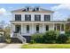 Stately two-story white home with dark shutters, a welcoming front porch, and manicured landscaping at 2 Piedmont Ave # A, Charleston, SC 29403