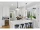 This bright eat-in kitchen features an island with barstool seating, granite counters, and stainless steel appliances at 2 Piedmont Ave # A, Charleston, SC 29403