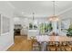 Bright eat-in kitchen features white cabinets, stainless appliances, and hardwood floors with an island and lots of natural light at 2 Piedmont Ave # A, Charleston, SC 29403